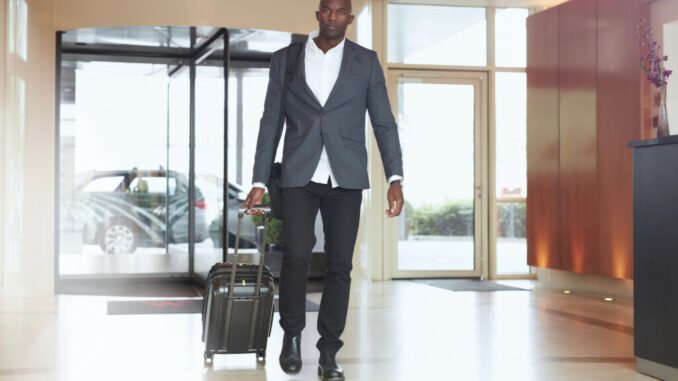 African businessman walking in hotel lobby