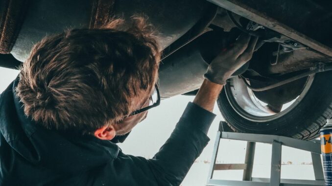 mecanics - car repair - man repairing a car