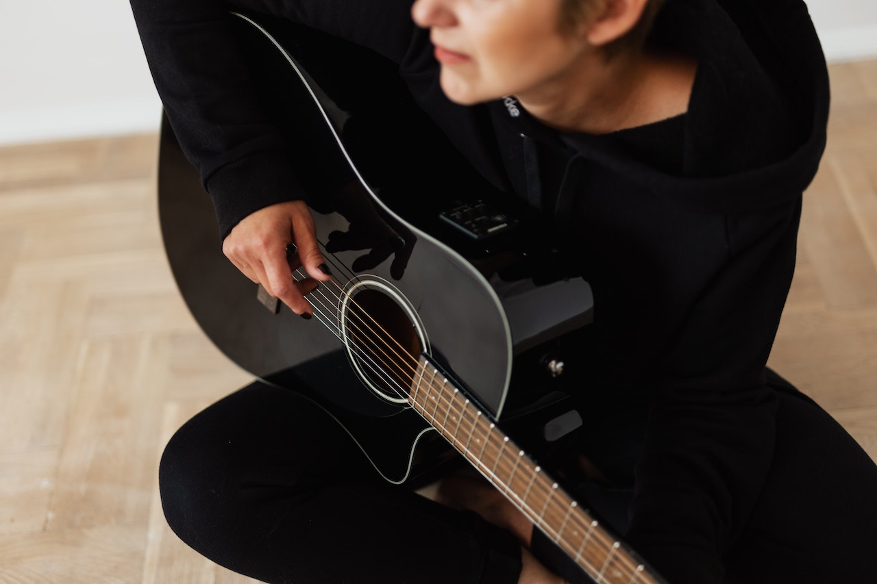 Person in black playing the guitar