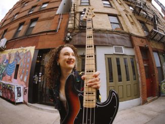 woman holding a bass guitar
