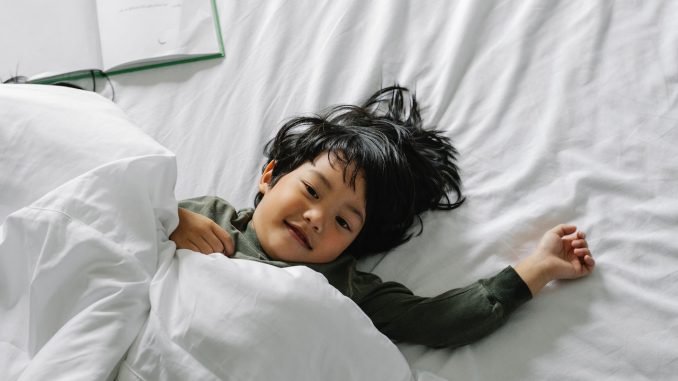 kid on a white bed - matress