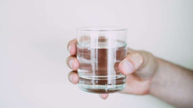 hand holding a glass of water