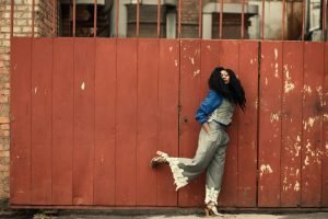 black woman wearing a grey pant and blue shirt 