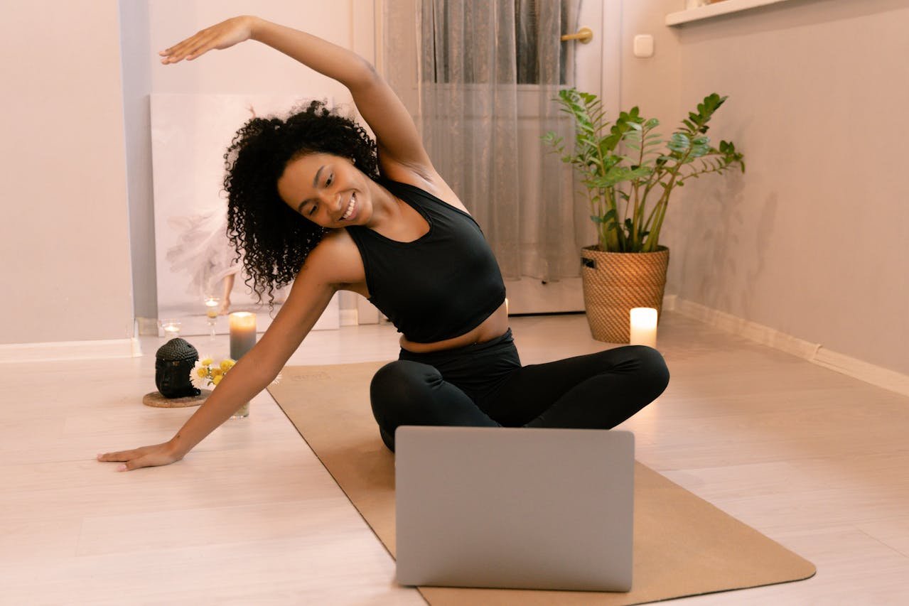 Woman practicing yoga and mindfulness in front of laptop – digital habits for mental wellness