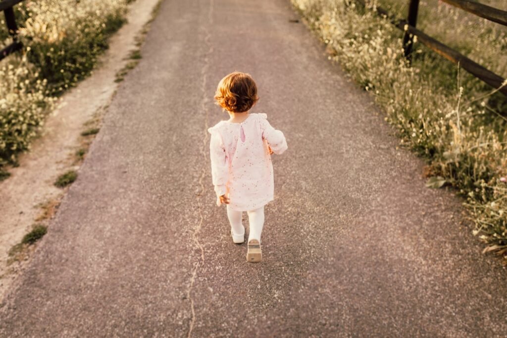 girl-wearing-white-clothes-walking-on-pavement-road