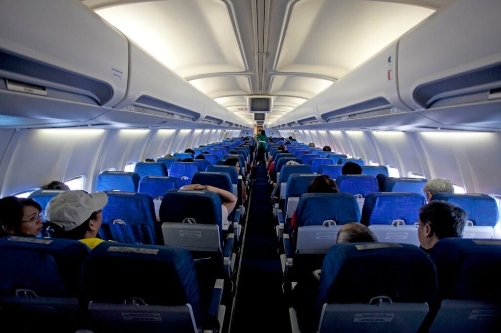 travel hacks for long flights - Inside airplane cabin – passengers seated during long-haul flight