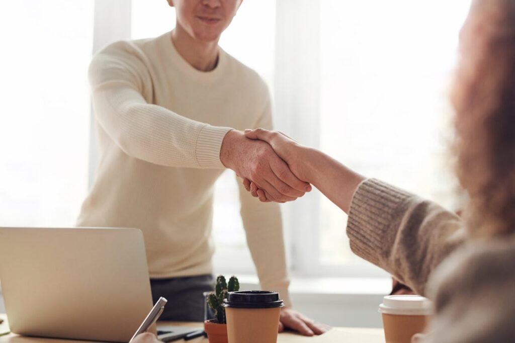 How to Get a Green Card  - Two people shaking hands after green card approval, symbolizing immigration success and new opportunities in America