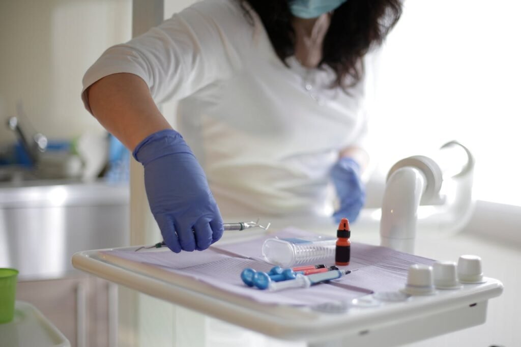 nurses in gloves holding a syringe