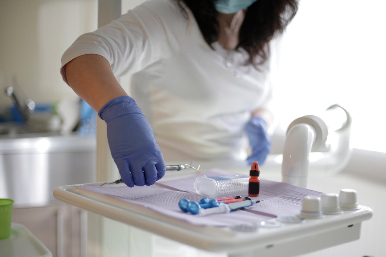 nurses in gloves holding a syringe