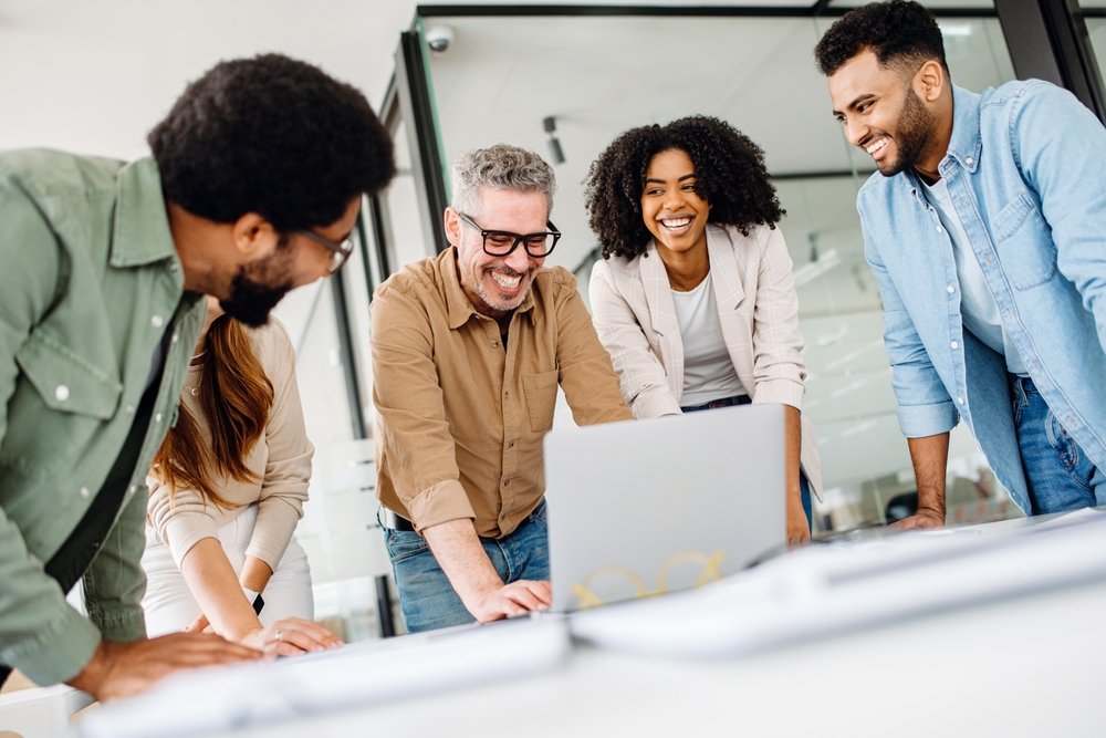 Wellness at Work A,Cheerful,Group,Of,Diverse,Coworkers,Lean,In,Around,A