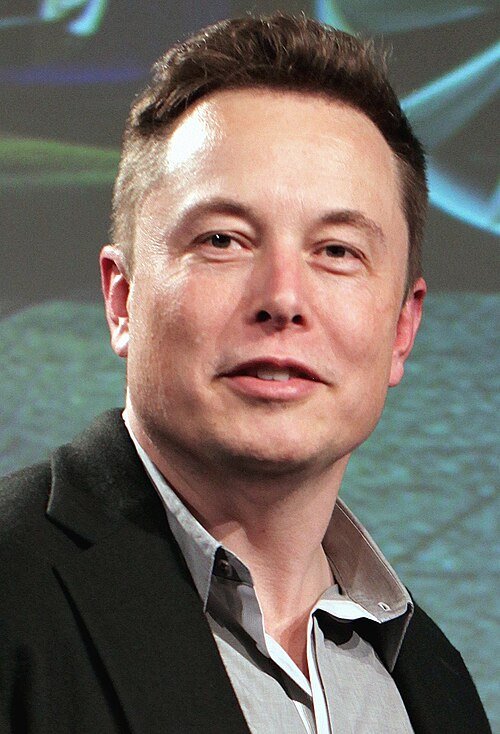 Elon Musk speaking at Tesla Motors annual meeting in 2015, symbolizing entrepreneur mindset shift and innovation.