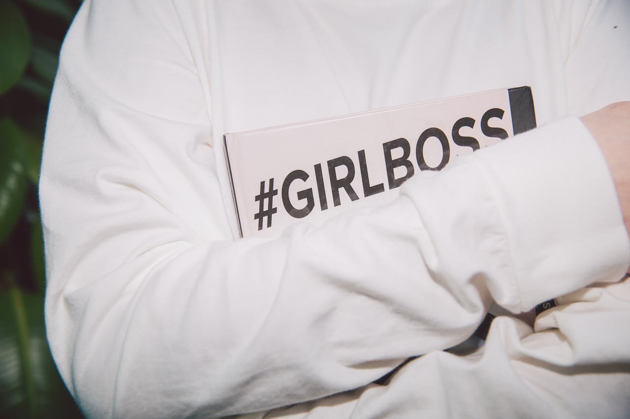 Entrepreneur holding a GirlBoss book symbolizing confidence, empowerment, and success in business