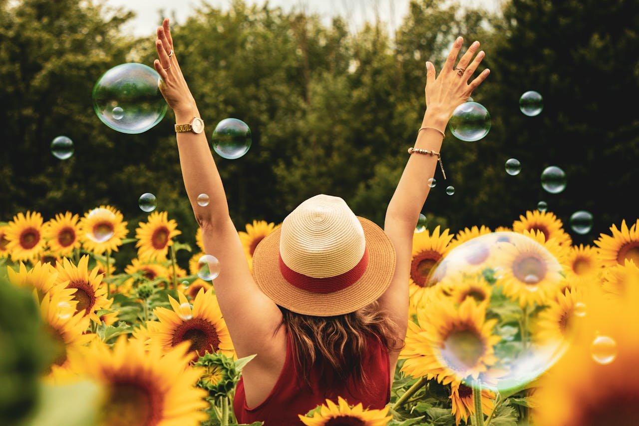 happy woman-surrounded-by-sunflowers
