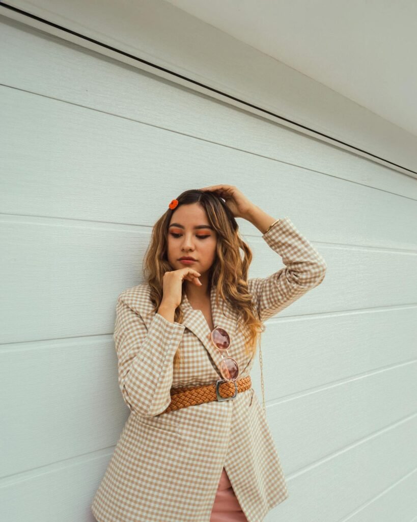 Cream tweed-style blazer outdoors, classic and polished.