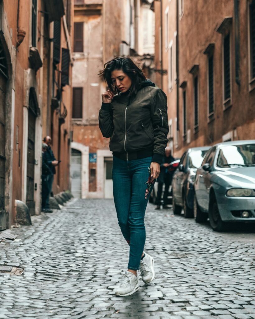Black oversized bomber jacket styled for daytime city street style.