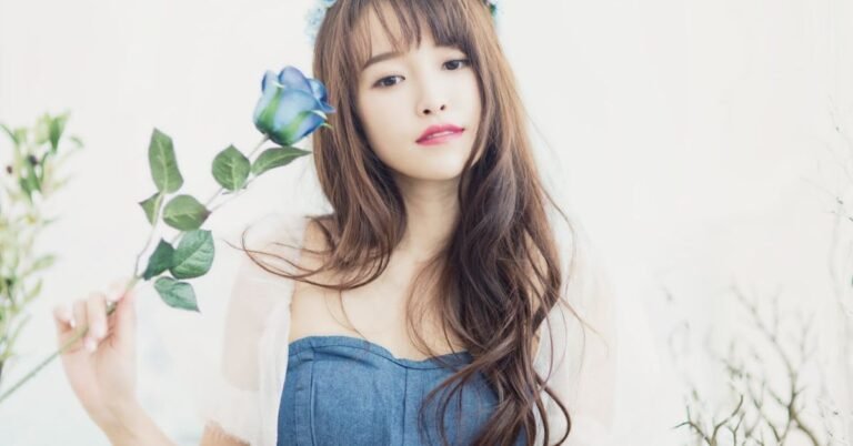 Young woman with radiant skin holding a flower, representing South Korean skincare and natural anti-aging beauty.