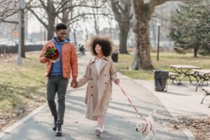 positive-black-couple-walking-in-park-with-dog-what to wear for your first date