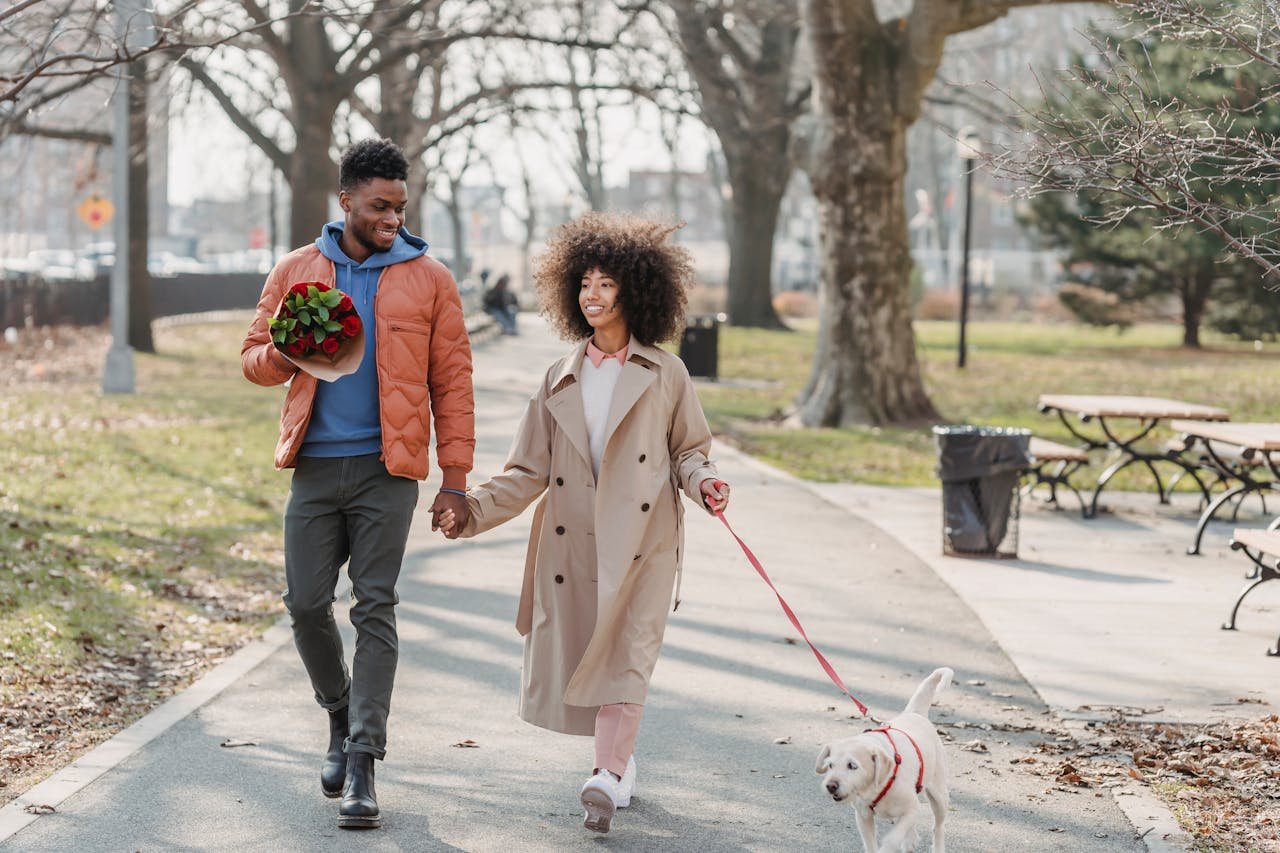 positive-black-couple-walking-in-park-with-dog-what to wear for your first date