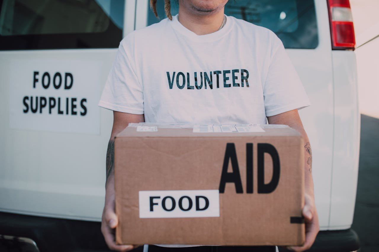 volunteer delivering food aid and supplies for world food day and global hunger relief