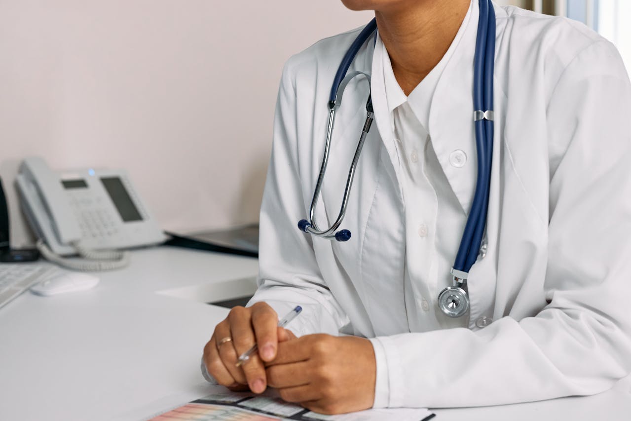 photoa-woman-in-white-coat-sitting-at-the-table -healthcare provider