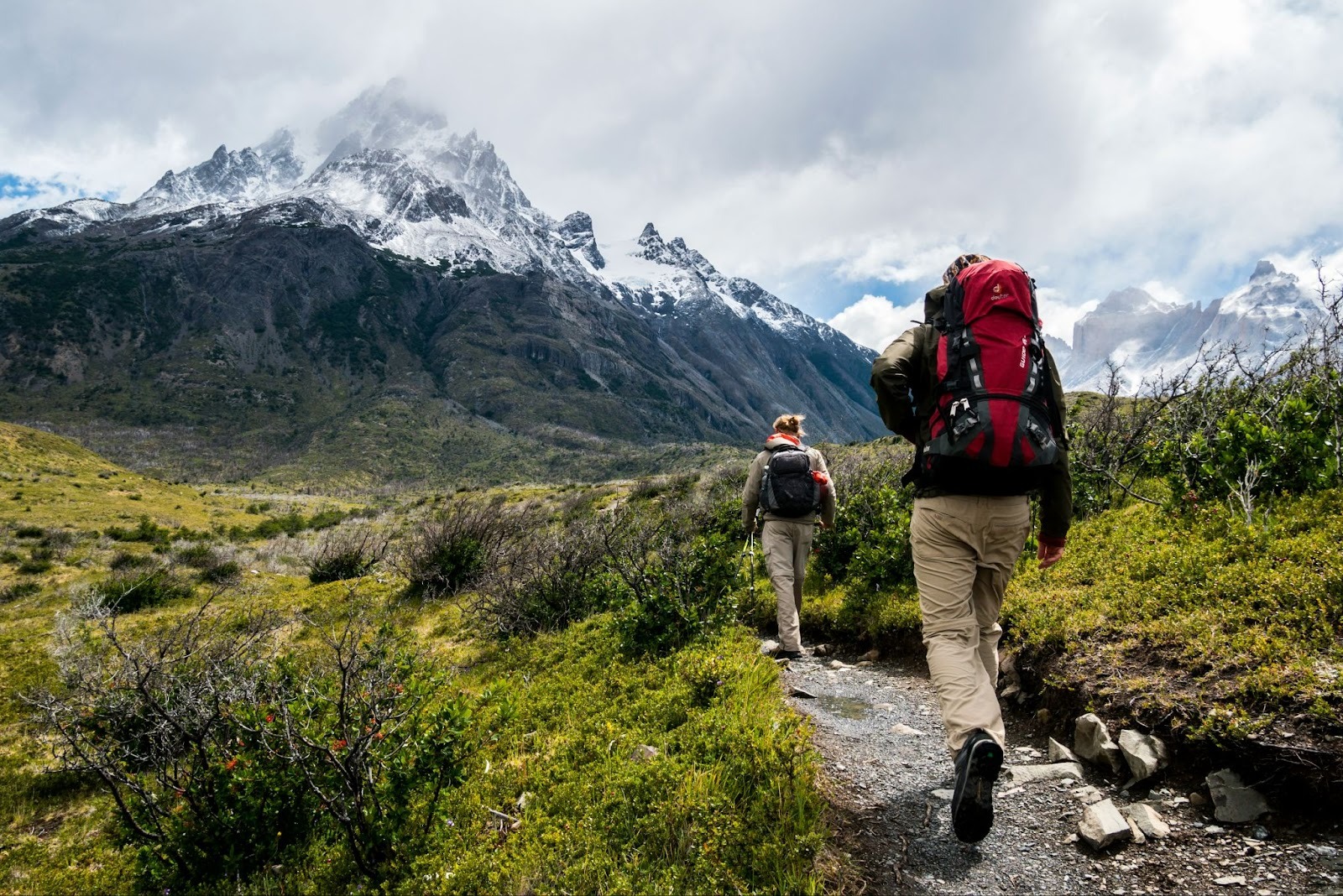 Hikers trekking in mountainous landscape.
