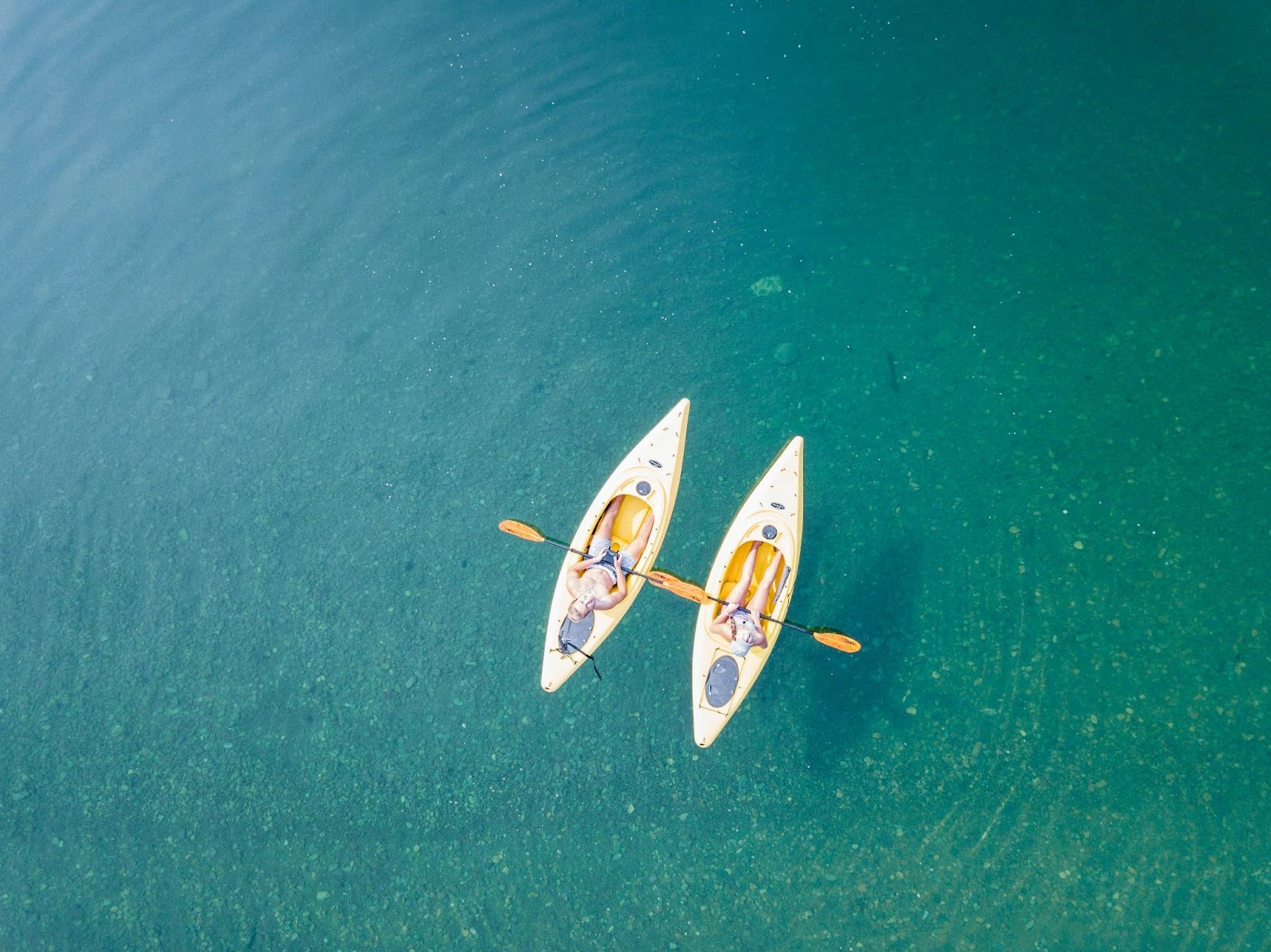 Two kayakers on clear water