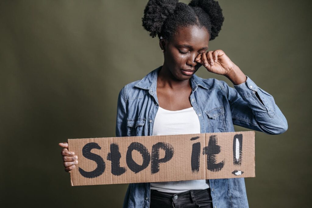 Human trafficking awareness woman holding Stop It protest sign