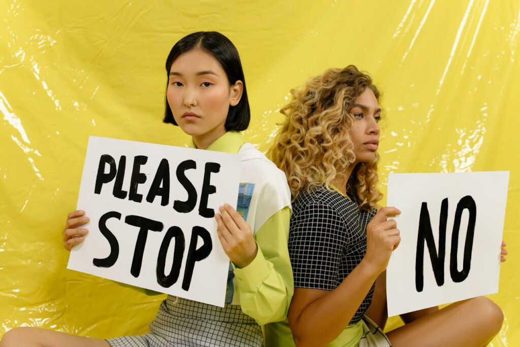 women holding signs saying please stop and no human trafficking awareness