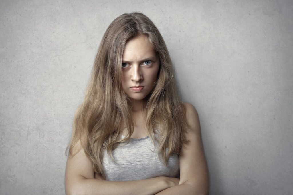 Woman expressing anger and bitterness symbolizing Post-Traumatic Embitterment Disorder PTED