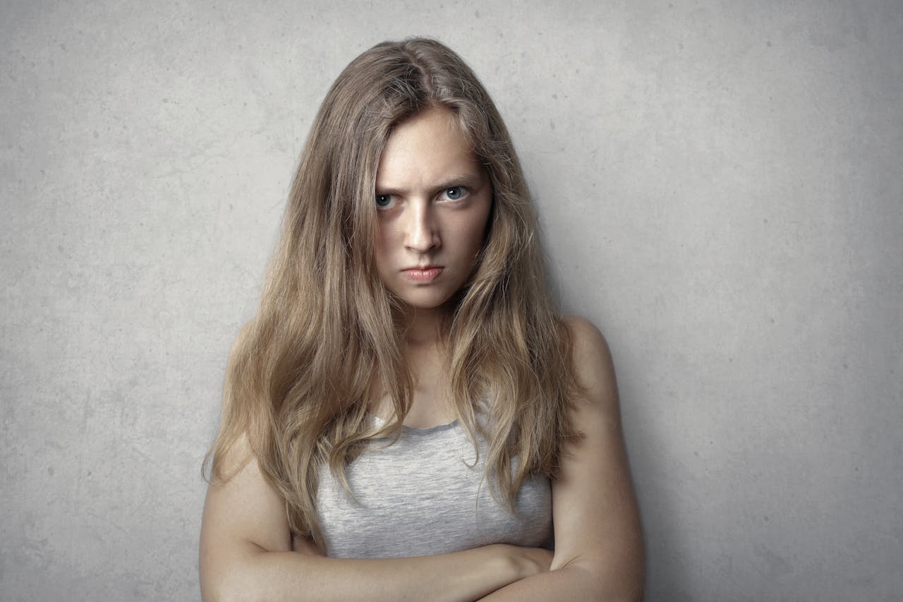 Woman expressing anger and bitterness symbolizing Post-Traumatic Embitterment Disorder PTED
