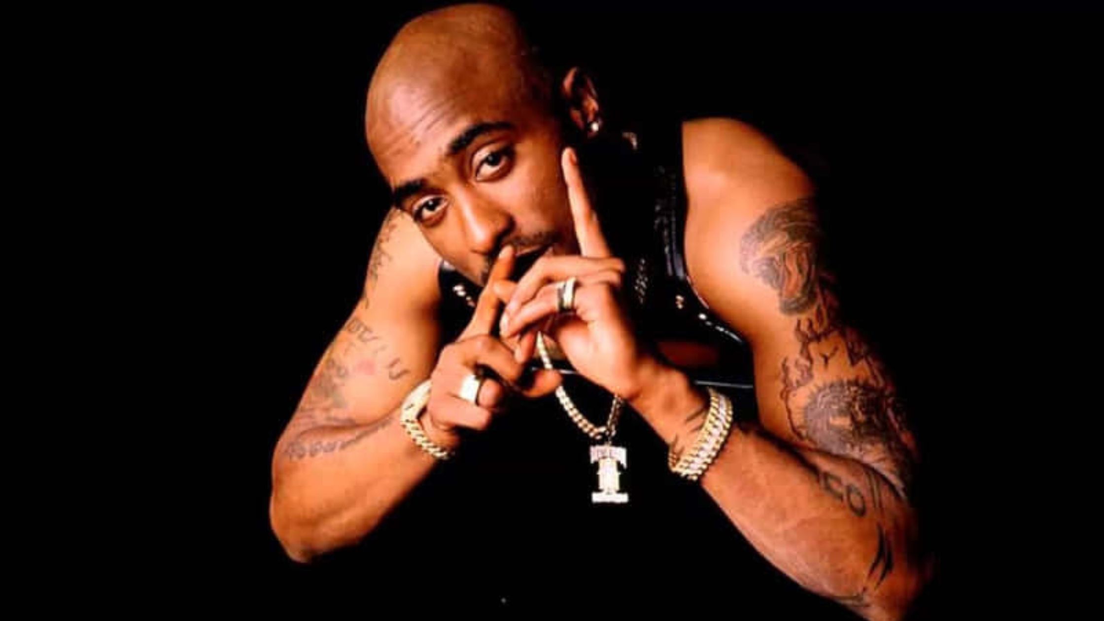 Man with tattoos making gesture