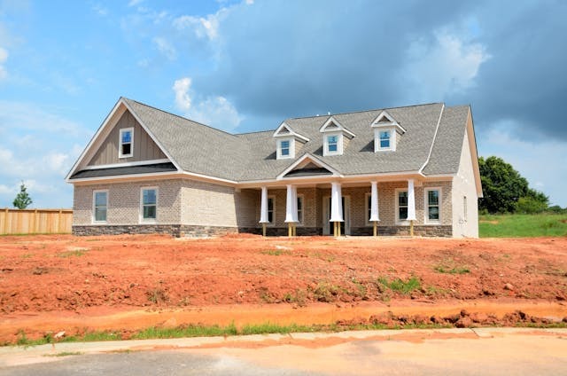 New house on red dirt lot