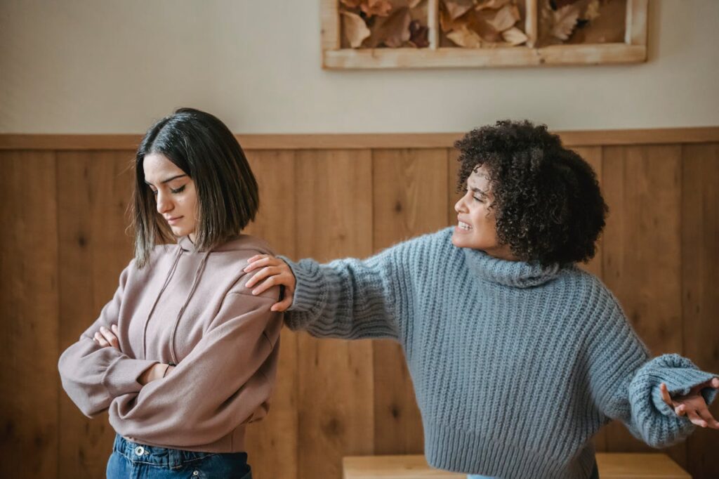 Two women showing emotional tension and conflict representing signs of a toxic friendship and mental health struggles