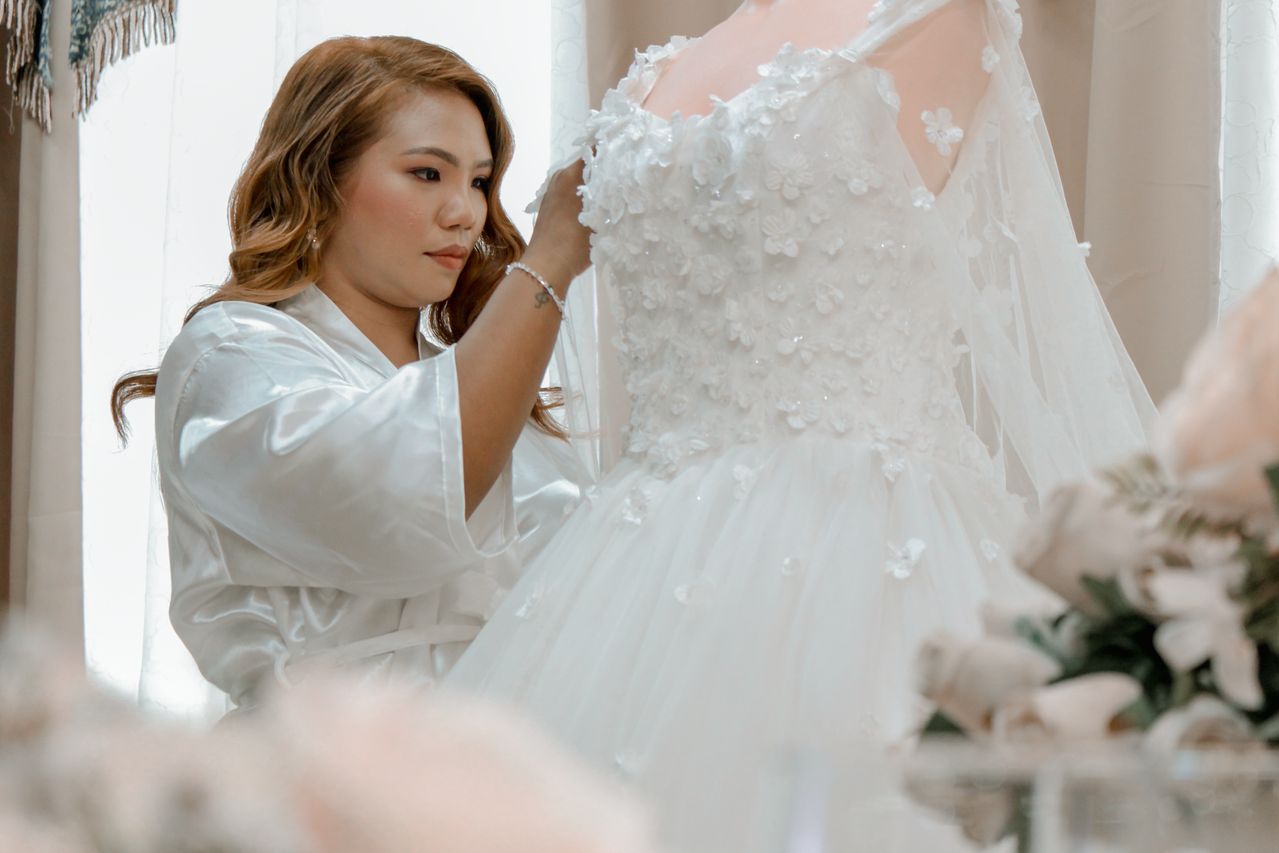 woman looking at a plus sized wedding dress-