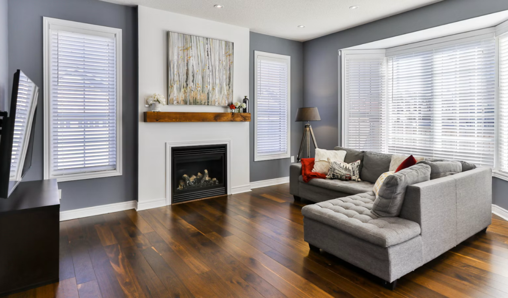 gray couch on brown wooden parquet flooring