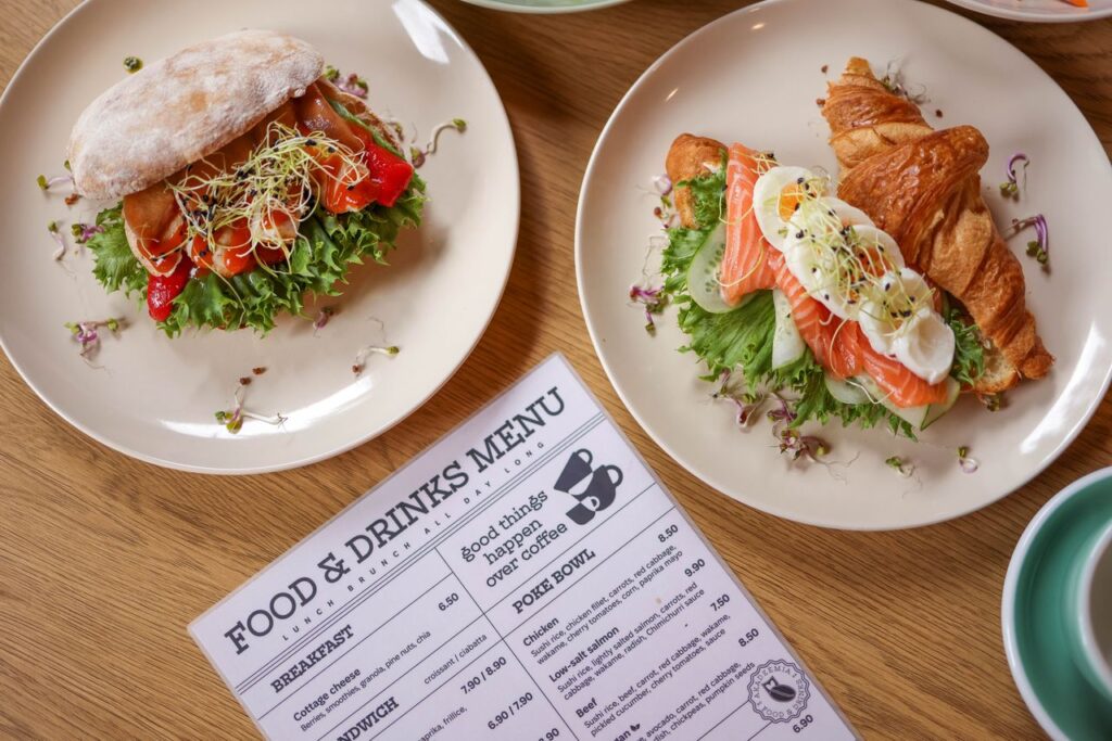 two-plates-with-sandwiches-and-a-menu-on-them