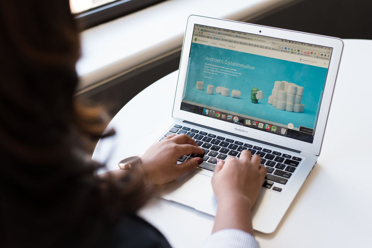 woman-sitting-near-table-using-macbook-business-internet-providers